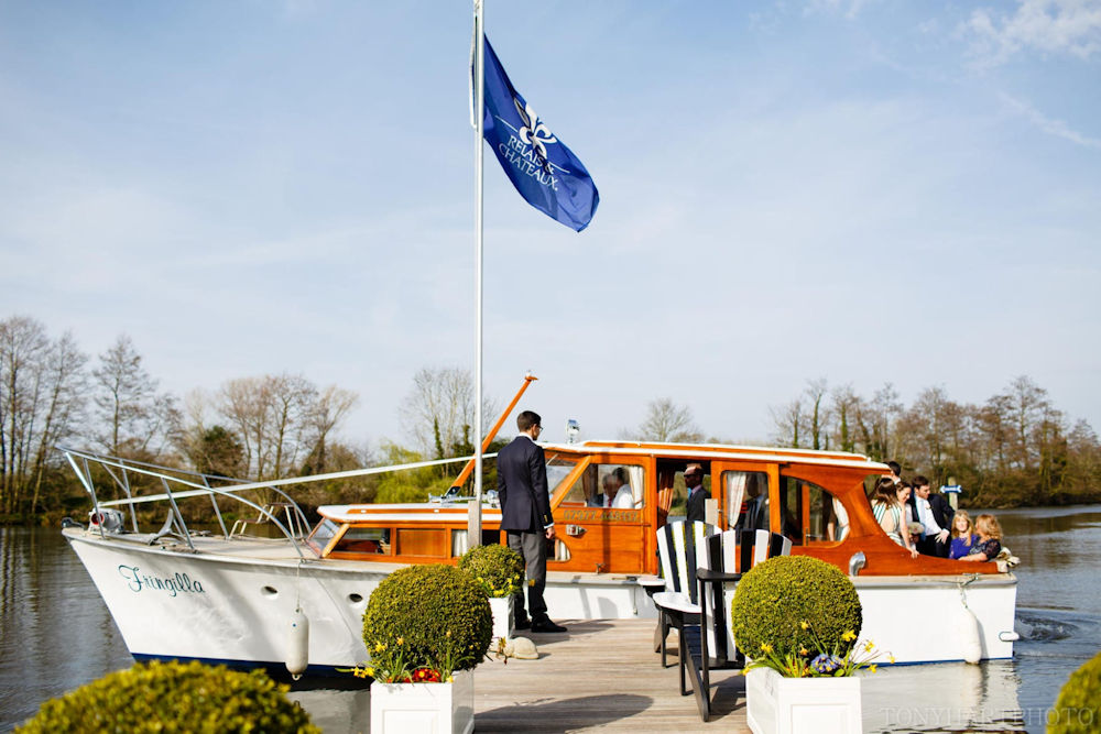 Guests arriving by boat at The Waterside Inn on The Boat Hire Company's Fringilla private hire vessel